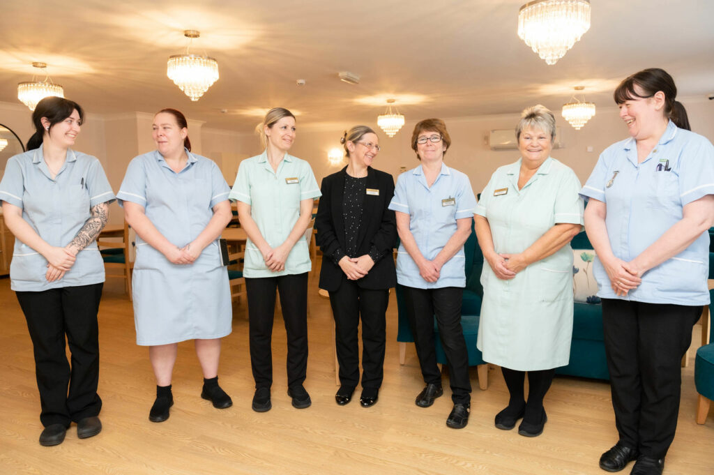 5 members of staff together.